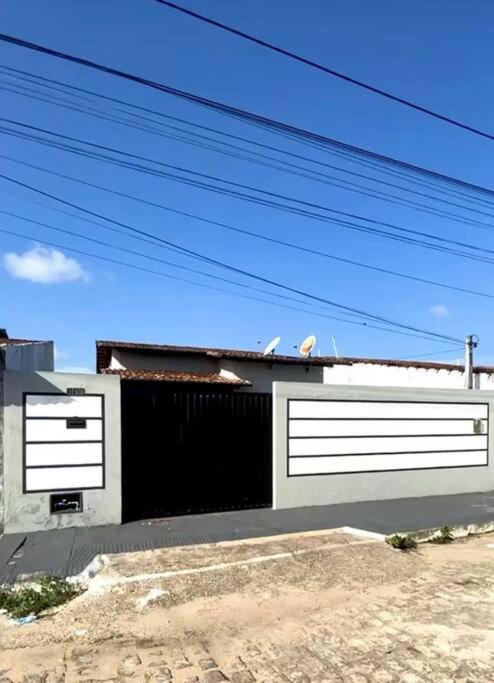 a building with a black and white garage at Casa no Litoral Norte de Natal in Extremóz