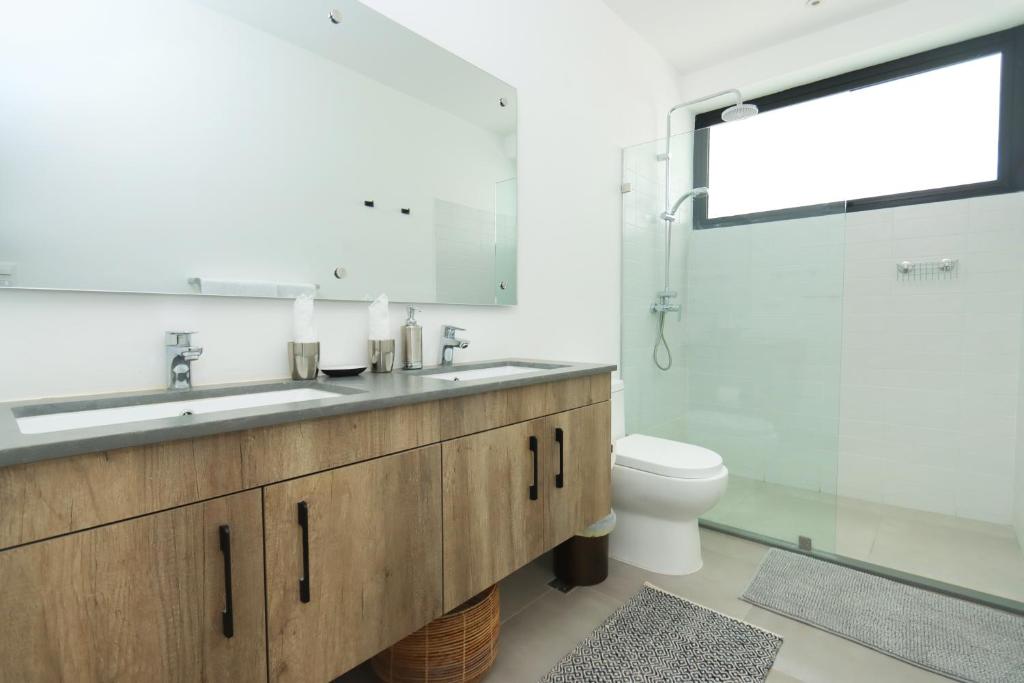 a bathroom with a sink and a toilet at Lumina at Flats Punta Cana Village in Punta Cana