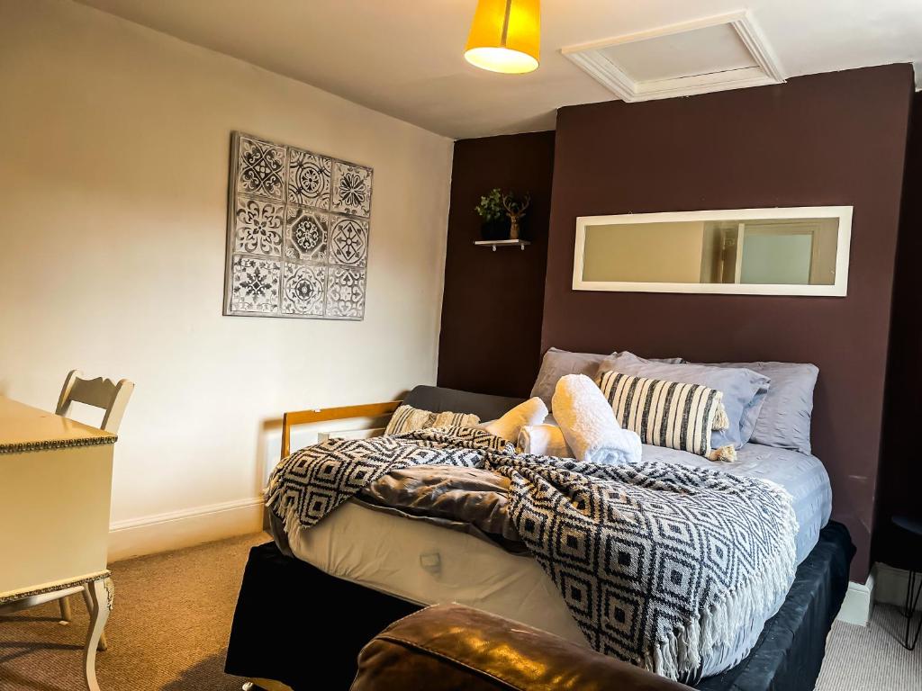 a bedroom with a bed with a blanket on it at Spacious House with 4 parking spaces in Canterbury