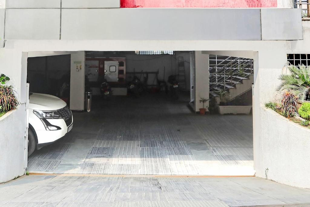 a garage with a car parked inside of it at Collection O SSR Royal Suites in Lingampalli