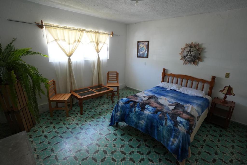 Postel nebo postele na pokoji v ubytování Hostal Casa Del Sol Comitan