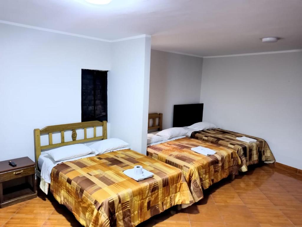 Llit o llits en una habitació de Hotel Los Chankas 1