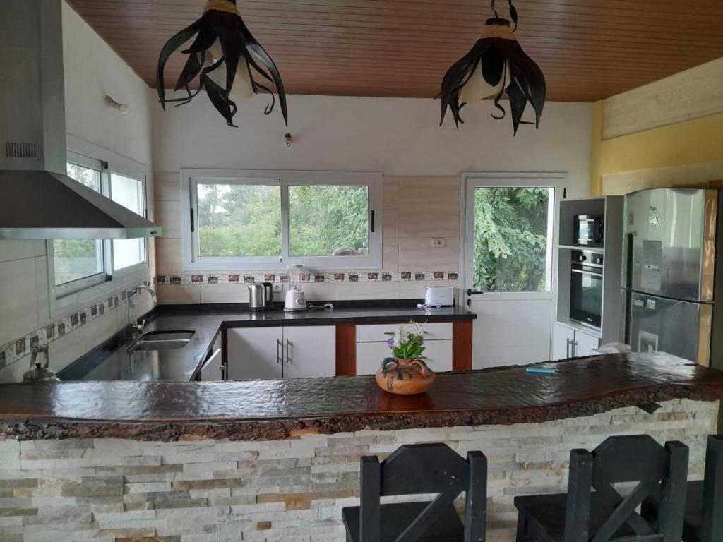 a kitchen with a large island in the middle at Casa de Campo La Querencia in Mercedes