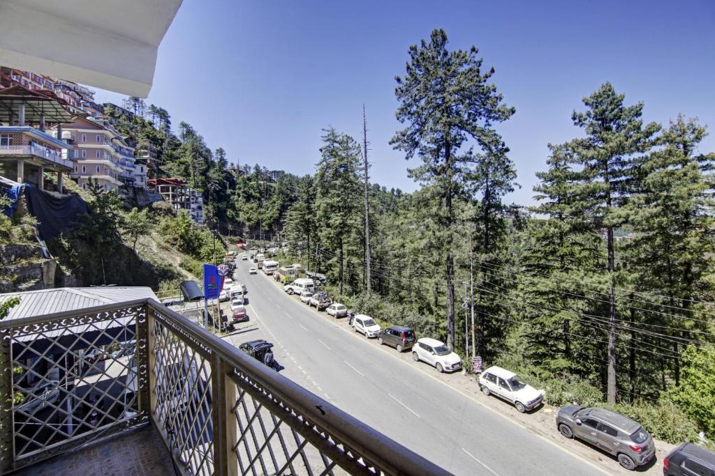 a view of a street with cars parked on the road at OYO Flagship The Green Park Shimla in Shimla