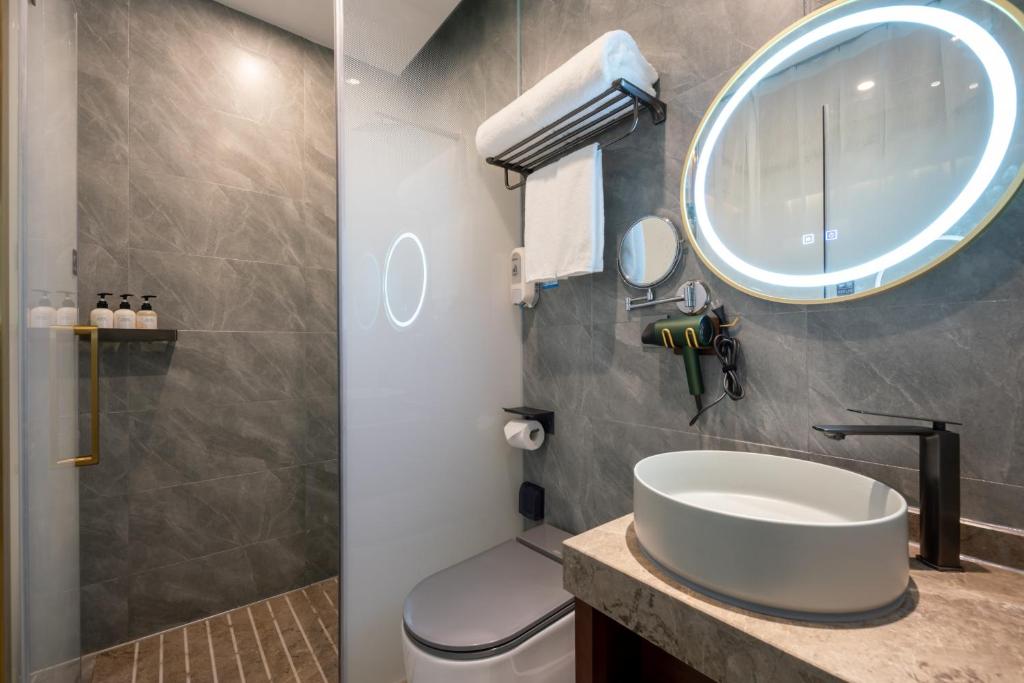a bathroom with a sink and a mirror at Nost algia S Hotel Near Chengdu Kuanzhai Alley - People's Park, Chengdu Panda Base, 10 minutes walk to subway , Free laundry, English communication well, Free coffee,Free travel advice in Chengdu