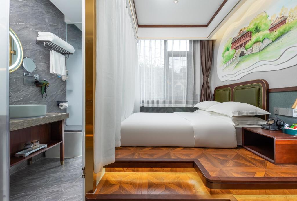 a hotel room with a bed and a sink at Nost algia S Hotel Near Chengdu Kuanzhai Alley - People's Park, Chengdu Panda Base, 10 minutes walk to subway , Free laundry, English communication well, Free coffee,Free travel advice in Chengdu