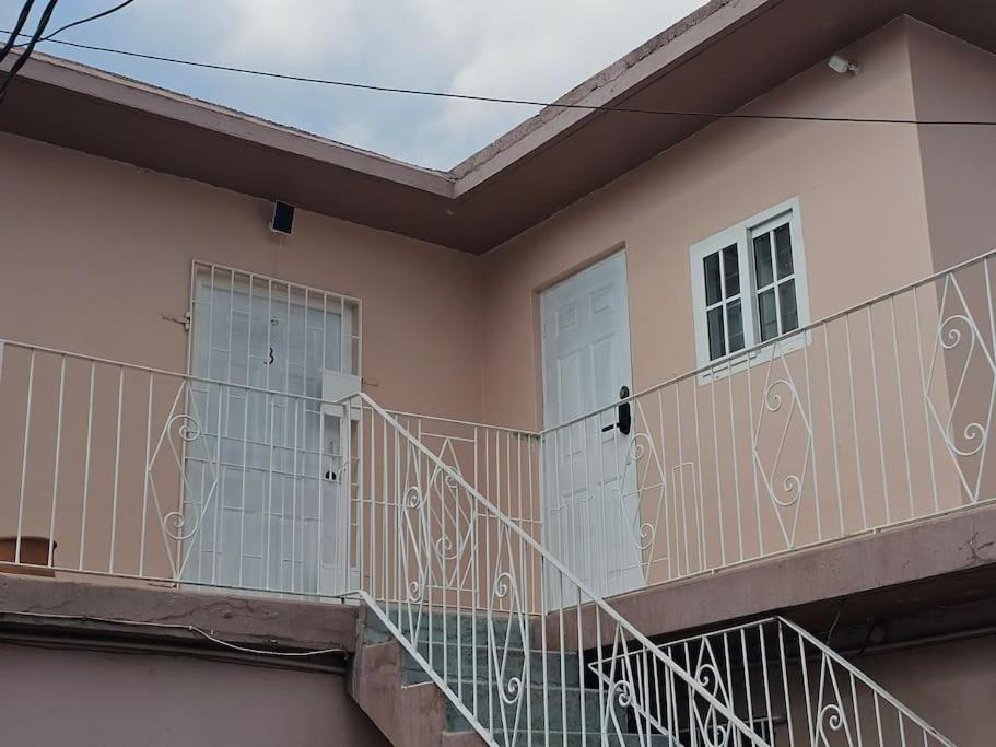 a balcony of a house with two doors at Skywin Airbnb - 1 Bedroom Apt&Sofa Bed - HWT, KGN in Camperdown