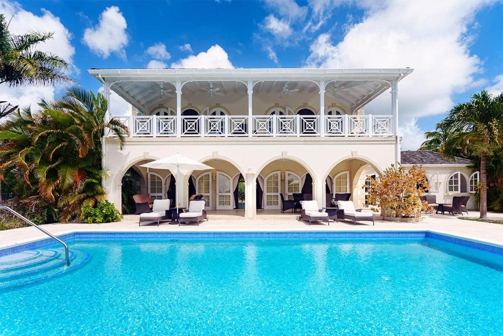 a villa with a swimming pool and a house at Royal Westmoreland - Ocean Drive 8 villa in Saint James