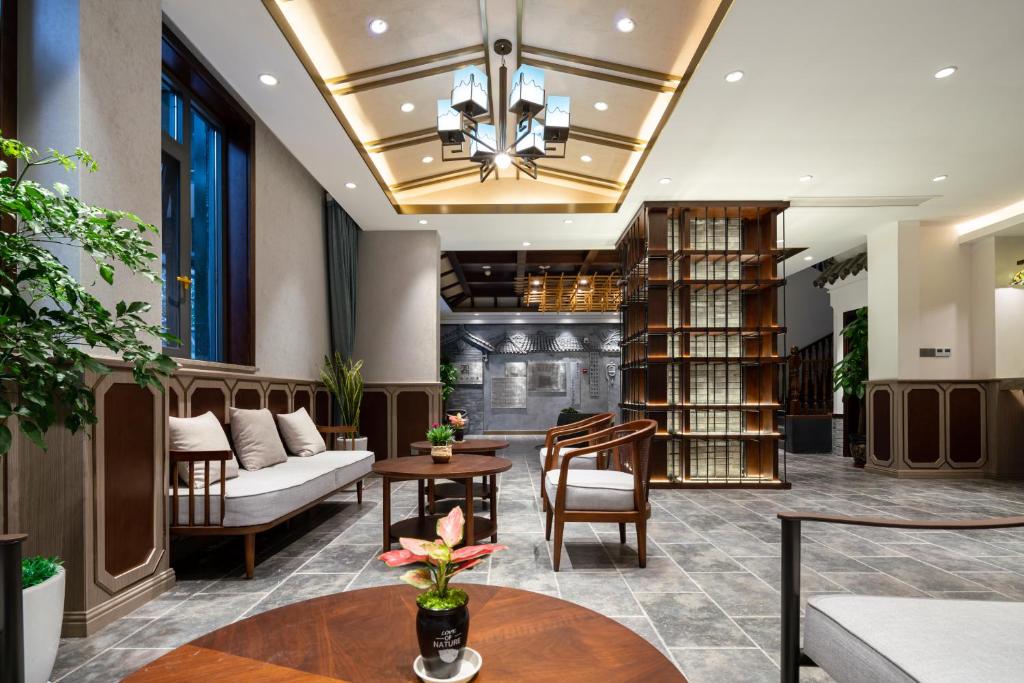 a lobby of a library with a couch and chairs at Nost algia S Hotel Near Chengdu Kuanzhai Alley - People's Park, Chengdu Panda Base, 10 minutes walk to subway , Free laundry, English communication well, Free coffee,Free travel advice in Chengdu