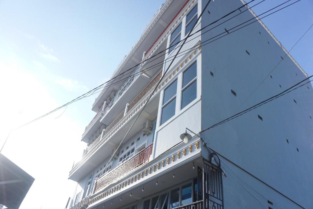 un edificio blanco alto con muchas ventanas en OYO 93773 Pondok Bintang en Kendari