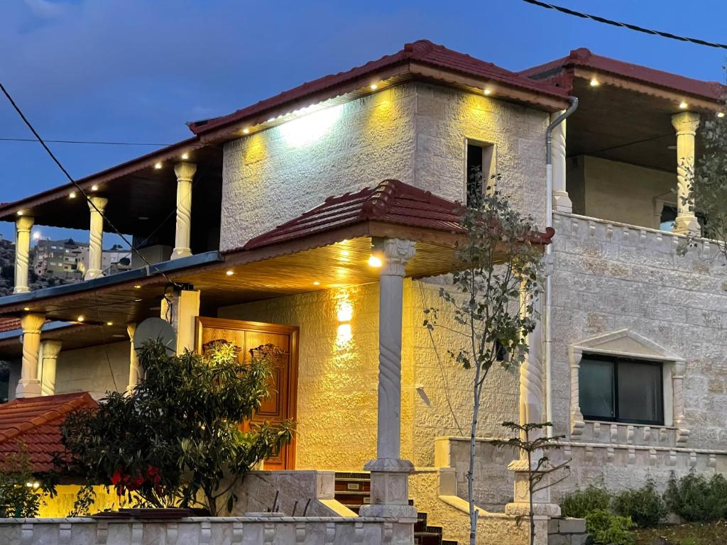 a house with lights on the front of it at furnished apartments for rent in Irbid