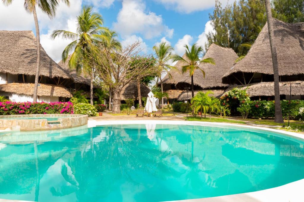 a swimming pool in front of a resort at Malindi Palm Villa- Harbour Key Cottages, Villa 16, Silver Sands Road in Malindi
