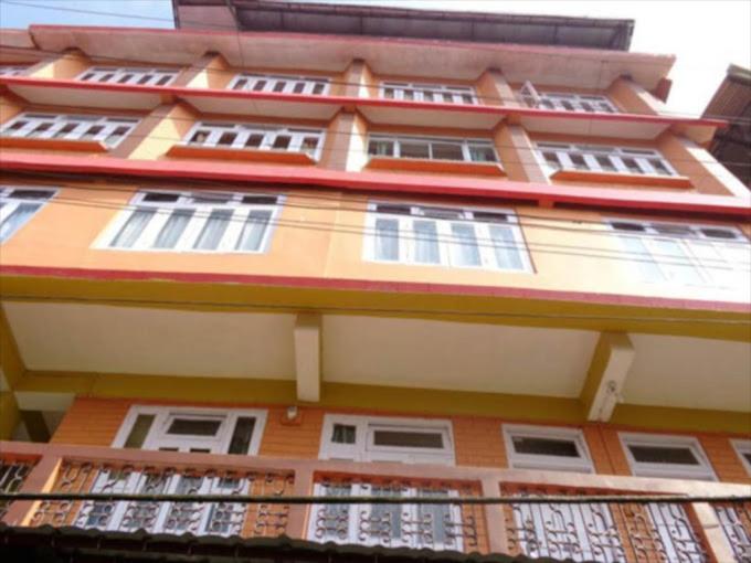 a tall building with many windows and a balcony at STAR HOTEL in Srinagar