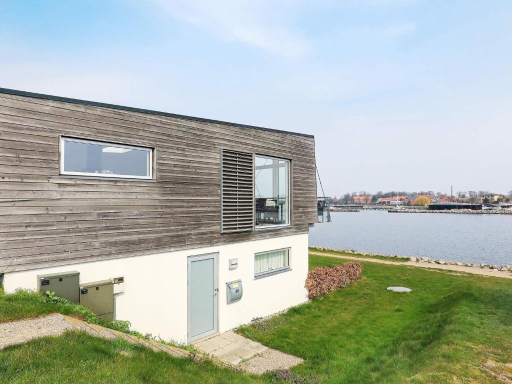 a house on the shore of a body of water at 5 person holiday home in Stege in Stege