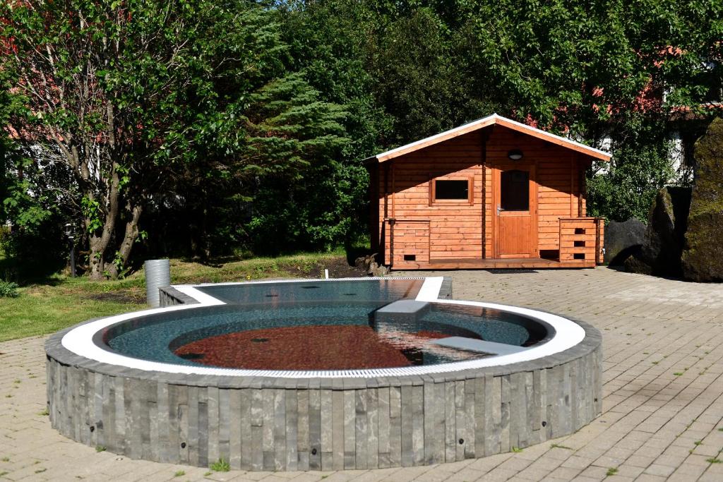 a swimming pool in front of a stone building at Hotel Katla by Keahotels in Vík