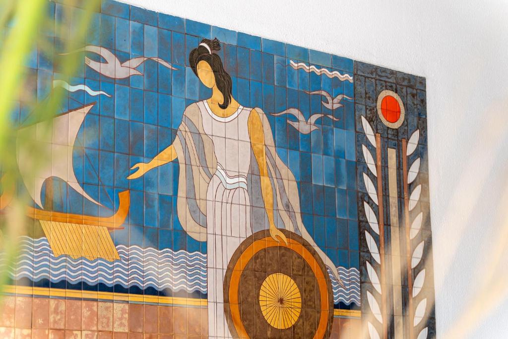 a painting of a woman on a tile wall at Oceanis Hotel in Kavála