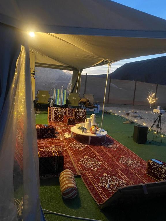 a tent with a table and chairs in it at كرفان vip مع ضيافة in Riyadh