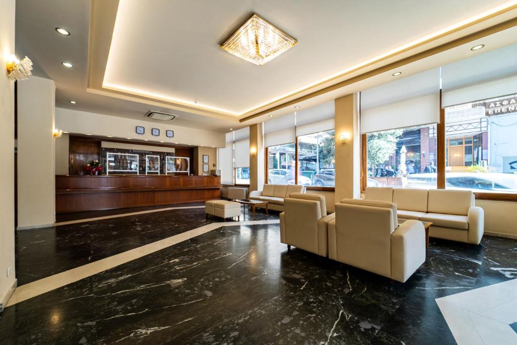 a lobby with chairs and a waiting room at Oceanis Hotel in Kavála