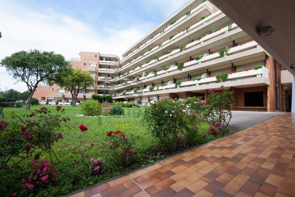 an external view of a building with a garden at Suites Marilia Apartments - Suite Livorno Holiday Home Group in Livorno