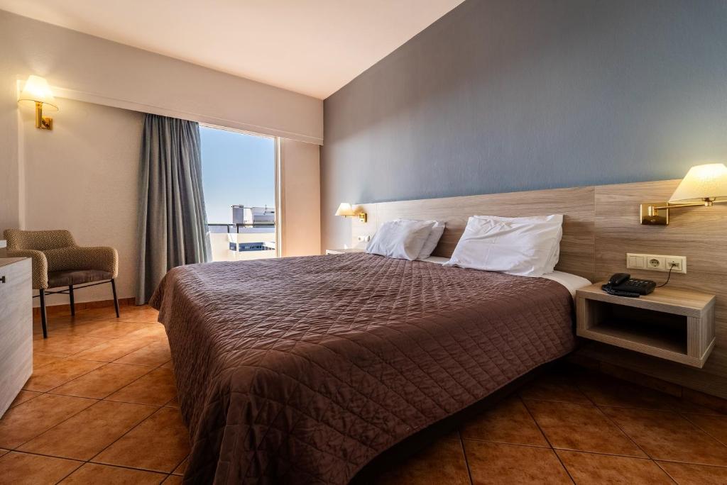 a hotel room with a bed and a window at Oceanis Hotel in Kavála