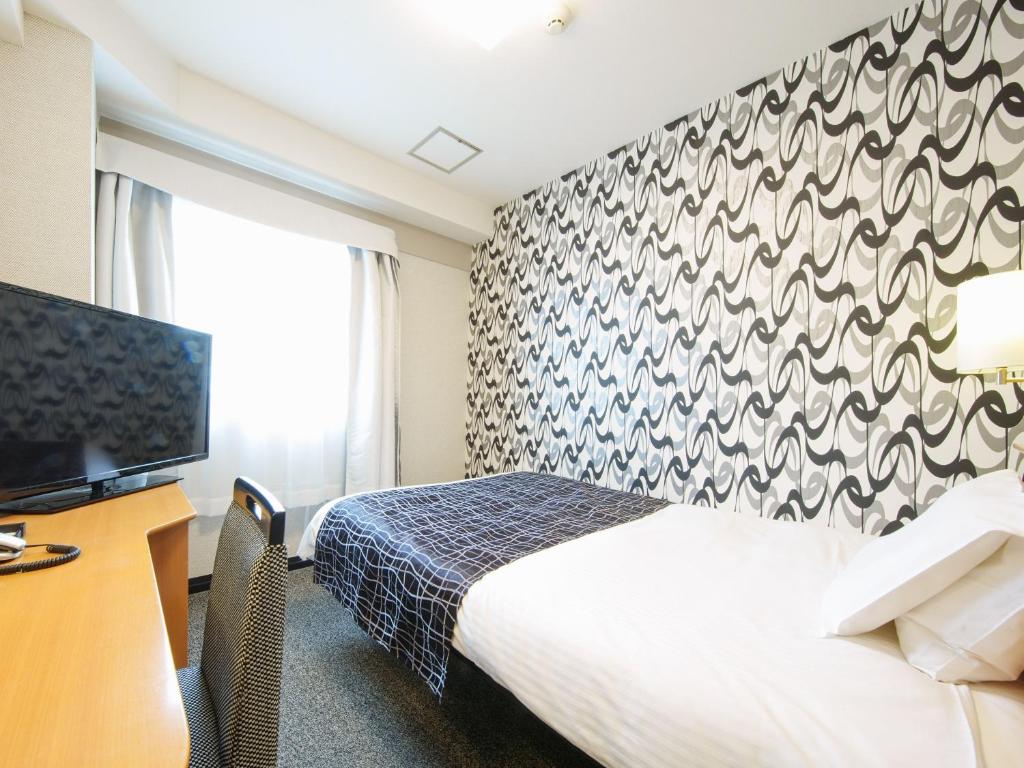 Postel nebo postele na pokoji v ubytování APA Hotel Kanku-Kishiwada