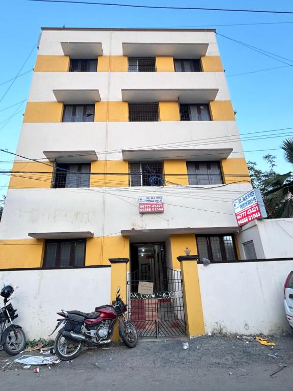 a motorcycle parked in front of a building at M K Raja Hotel in Kelambākkam