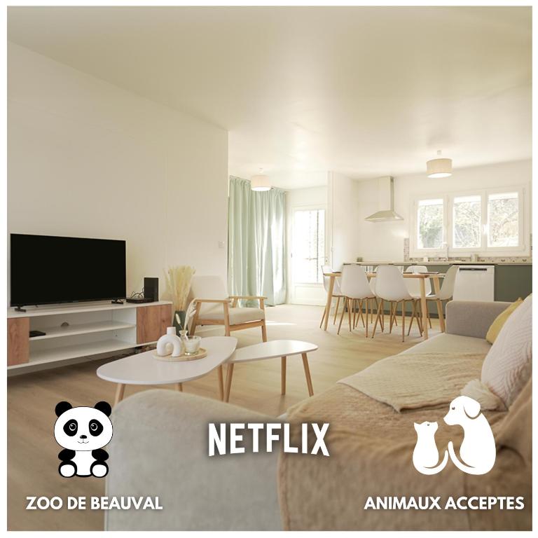 un salon avec un canapé et une télévision dans l'établissement Au calme - Maison avec grand jardin - Proche zoo de Beauval, à Vicq-sur-Nahon