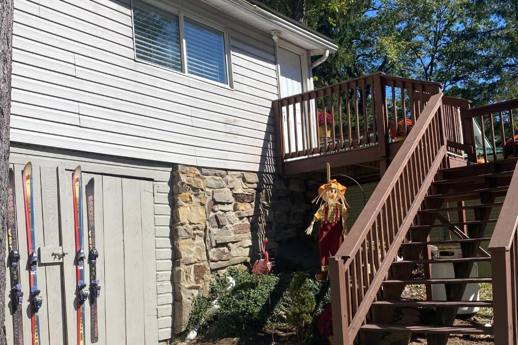 a house with a wooden staircase next to a building at Alpine Dreams in Champion