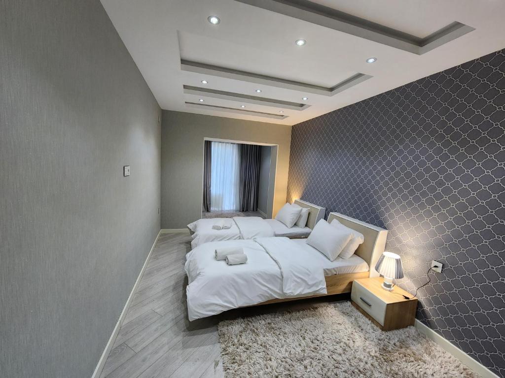 a large bedroom with a large bed and a table at Park Azure Best apartment in Baku