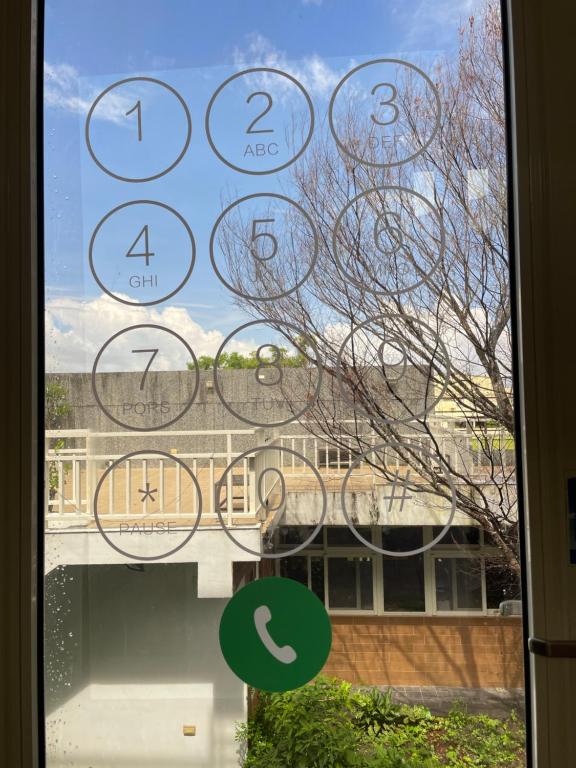 a window with numbers on it with a view of a building at I Leisure B&amp;B in Yuanshan