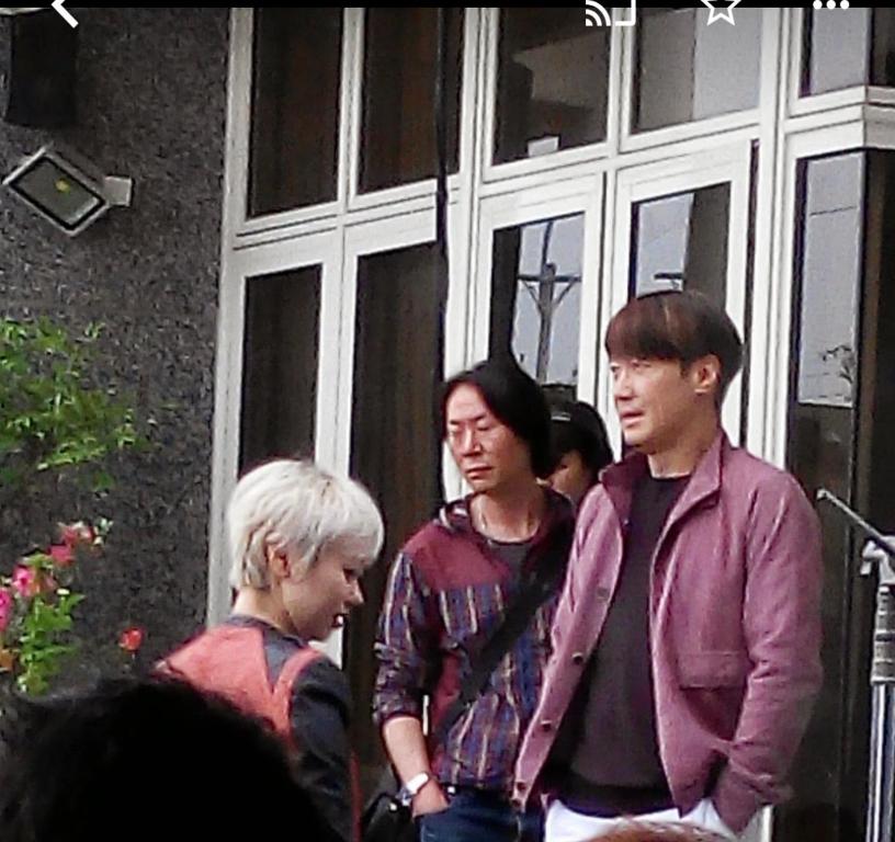 a group of people standing outside of a building at I Leisure B&amp;B in Yuanshan