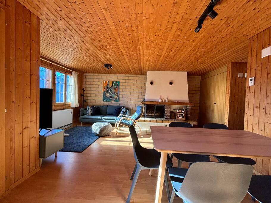 a living room with a table and some chairs at Ferienwohnung im Chalet Bergruh - Hasliberg Reuti in Hasliberg