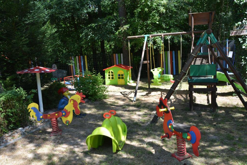 a childrens playground with a swing and a swing at Ośrodek Wypoczynkowy Puszczyk Domek Akacjowy- Apartament -Willa in Sieraków