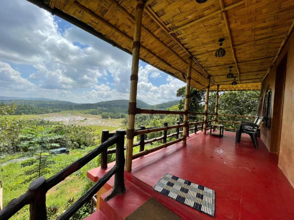 a porch of a house with a view of the mountains at ANGELSNESTMOUNTAINVIEW in Chekadi
