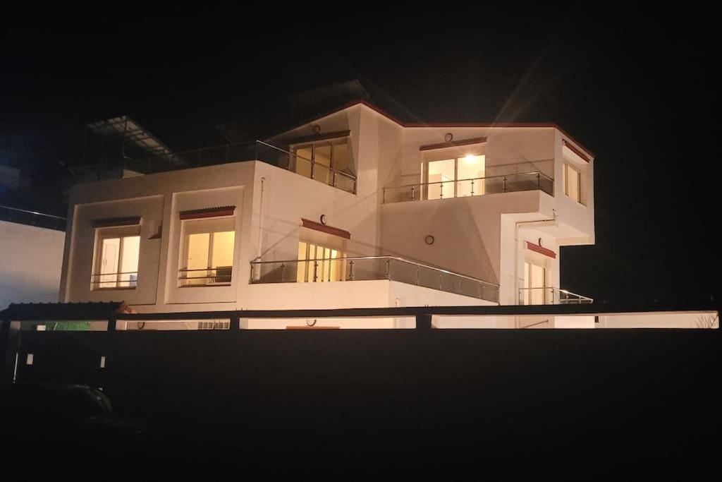 a large white house at night with its lights on at ILY House : Villa de plage avec piscine sans vis-à-vis. in Bejaïa