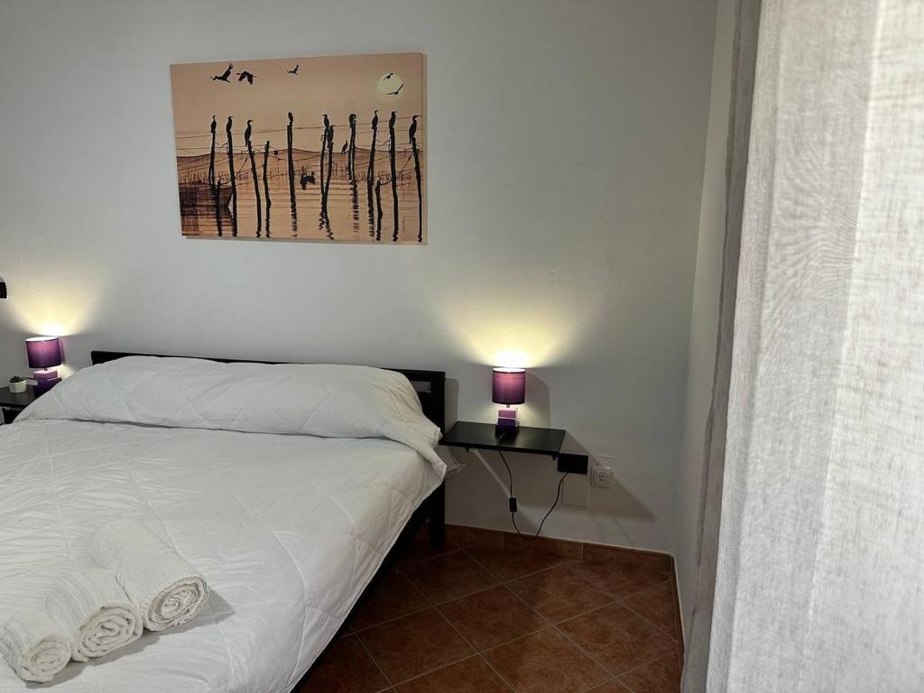 a bedroom with a bed and two tables with lamps at COSENZA Galluppi 23 in Cosenza