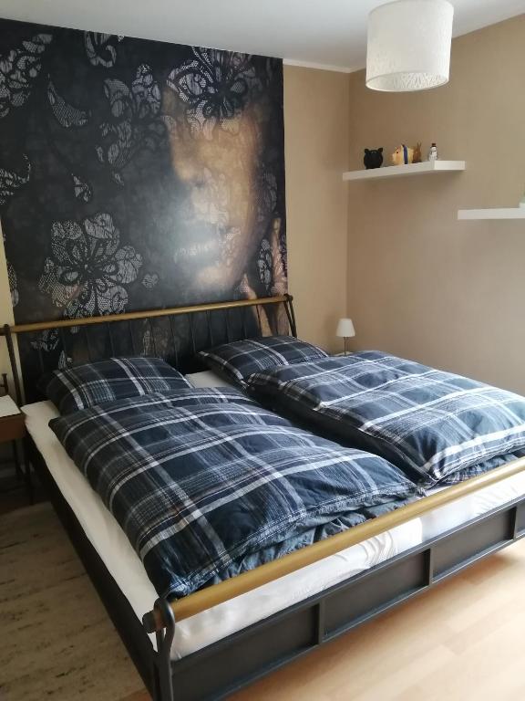 a bed in a room with a wall at Ferienwohnung Wörrstadt in Wörrstadt