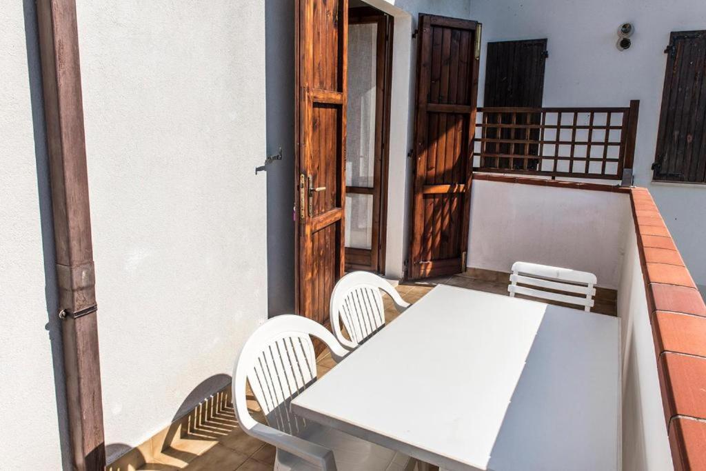 a white table and chairs on a balcony at Trilocale con A/C a Marcelli - M035 in Marcelli