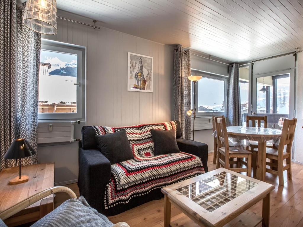 a living room with a couch and a table at Appartement La Clusaz, 3 pièces, 4 personnes - FR-1-304-46 in La Clusaz