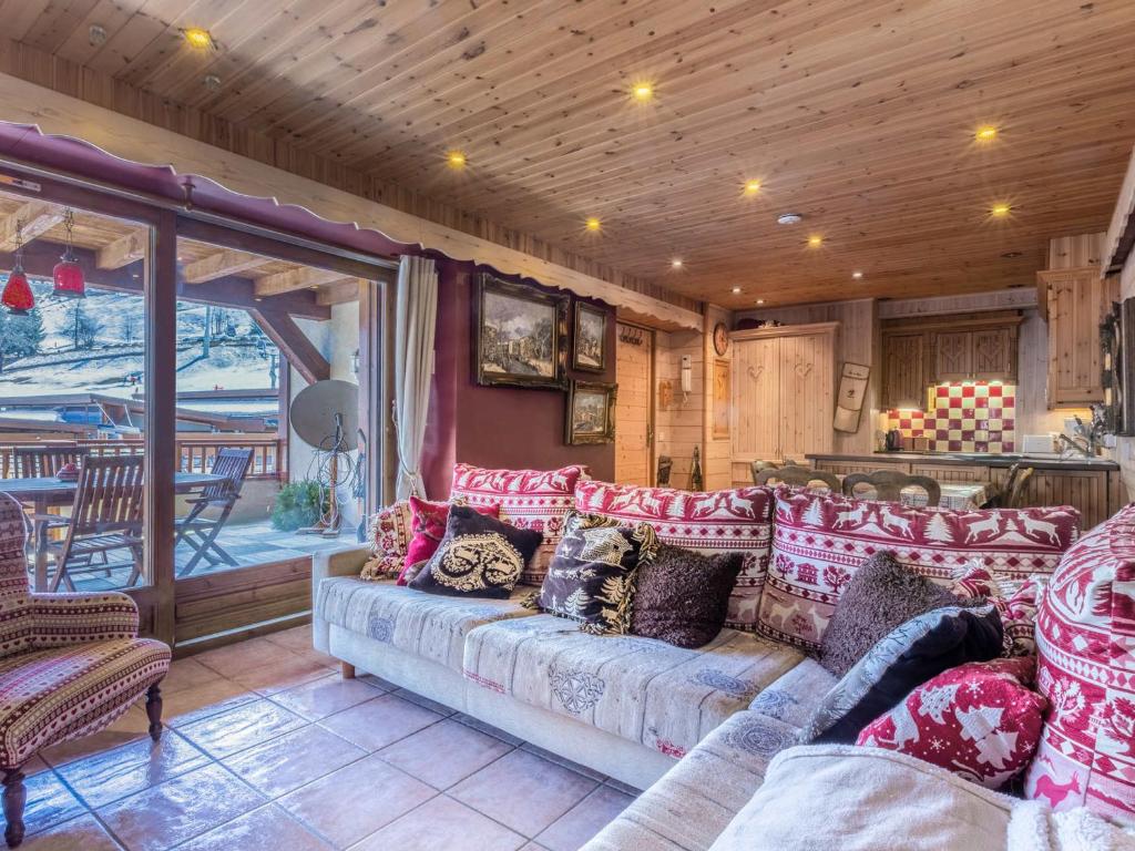 a living room with a couch with pillows on it at Appartement La Clusaz, 4 pièces, 6 personnes - FR-1-304-112 in La Clusaz