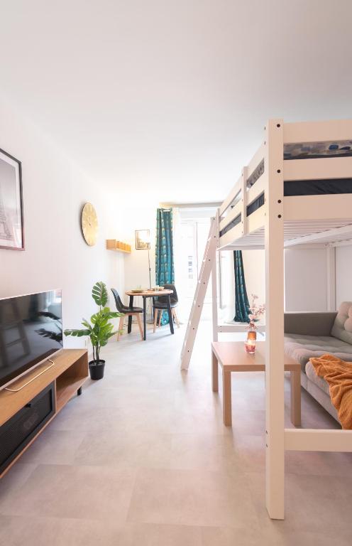 un salon avec un lit superposé et un canapé dans l'établissement Le Studieux 2-T1-25m2-Métro 7, au Kremlin-Bicêtre