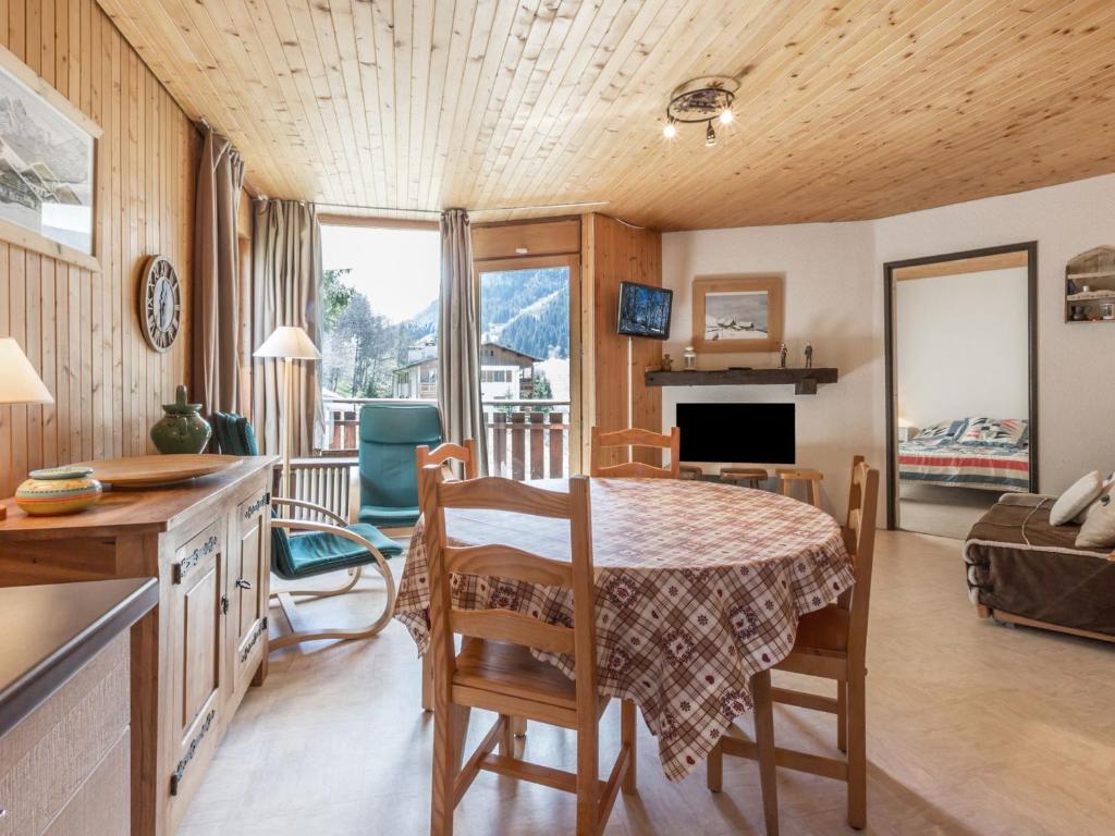 a kitchen and living room with a table and chairs at Appartement La Clusaz, 3 pièces, 6 personnes - FR-1-304-151 in La Clusaz