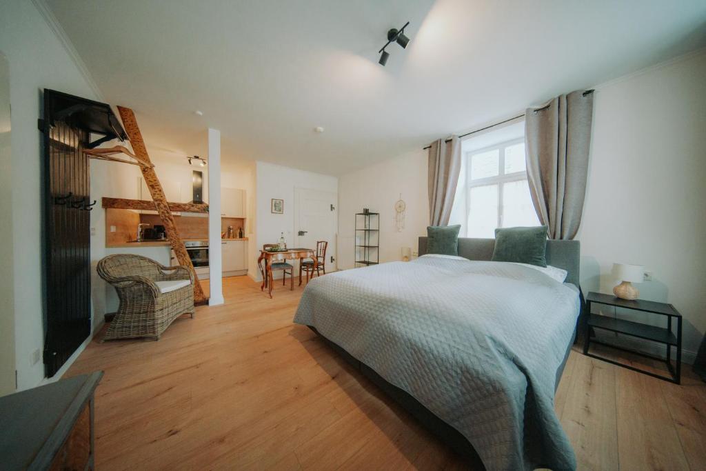 a bedroom with a bed and a dining room at Residenz Moselliebe in Traben-Trarbach