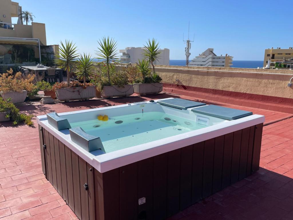 una vasca idromassaggio in cima a un edificio di 550 m2 Ocean Breeze, private Terrace & Jacuzzi by the sea a Benalmádena