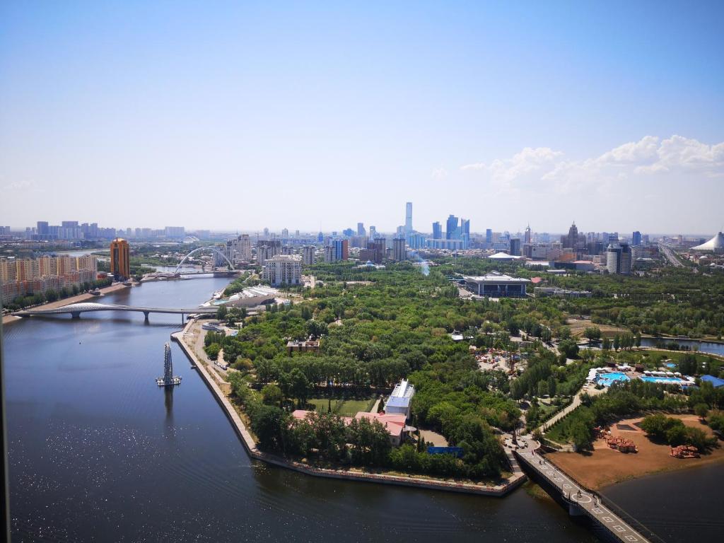 an aerial view of a river and a city at Grand Alatau in Astana