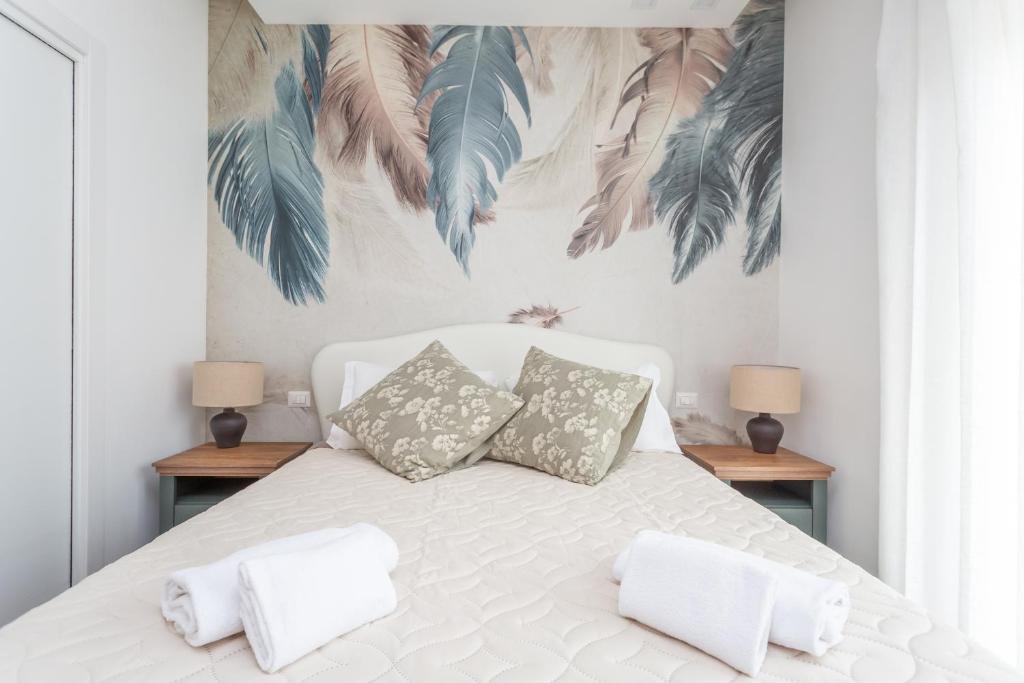 a bedroom with a white bed with two pillows at Gregory 7House Vaticano in Rome