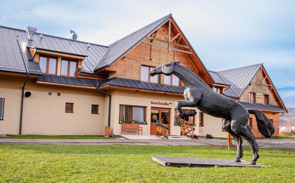 a statue of a horse in front of a house at Hotel Rozálka in Pezinok