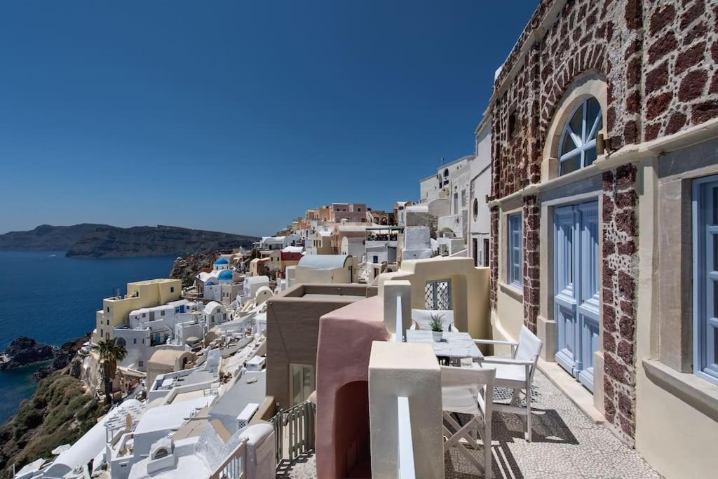 a view of a town with white buildings and the ocean at VILLA OIA 1880 in Oia