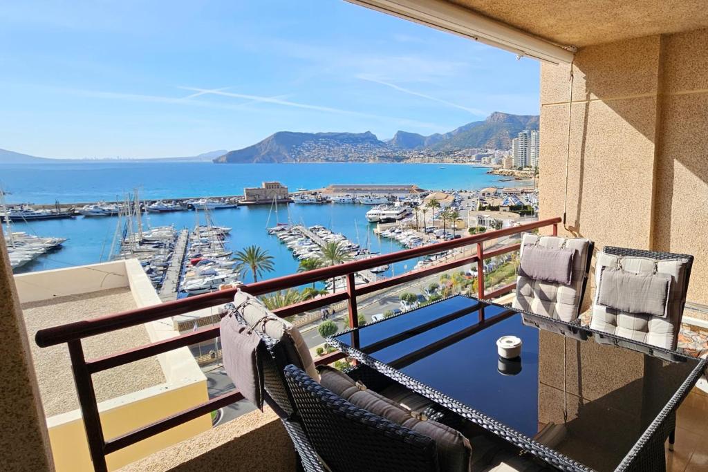 a balcony with chairs and a view of a marina at Apartment Marina in Calpe