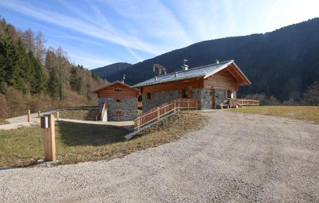 a building on the side of a road next to a mountain at Amazing Home In Castello Tesino With House A Mountain View in Castello Tesino